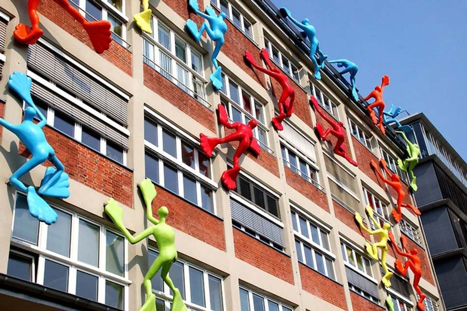 The façade climbers in Düsseldorf ascending business buildings.