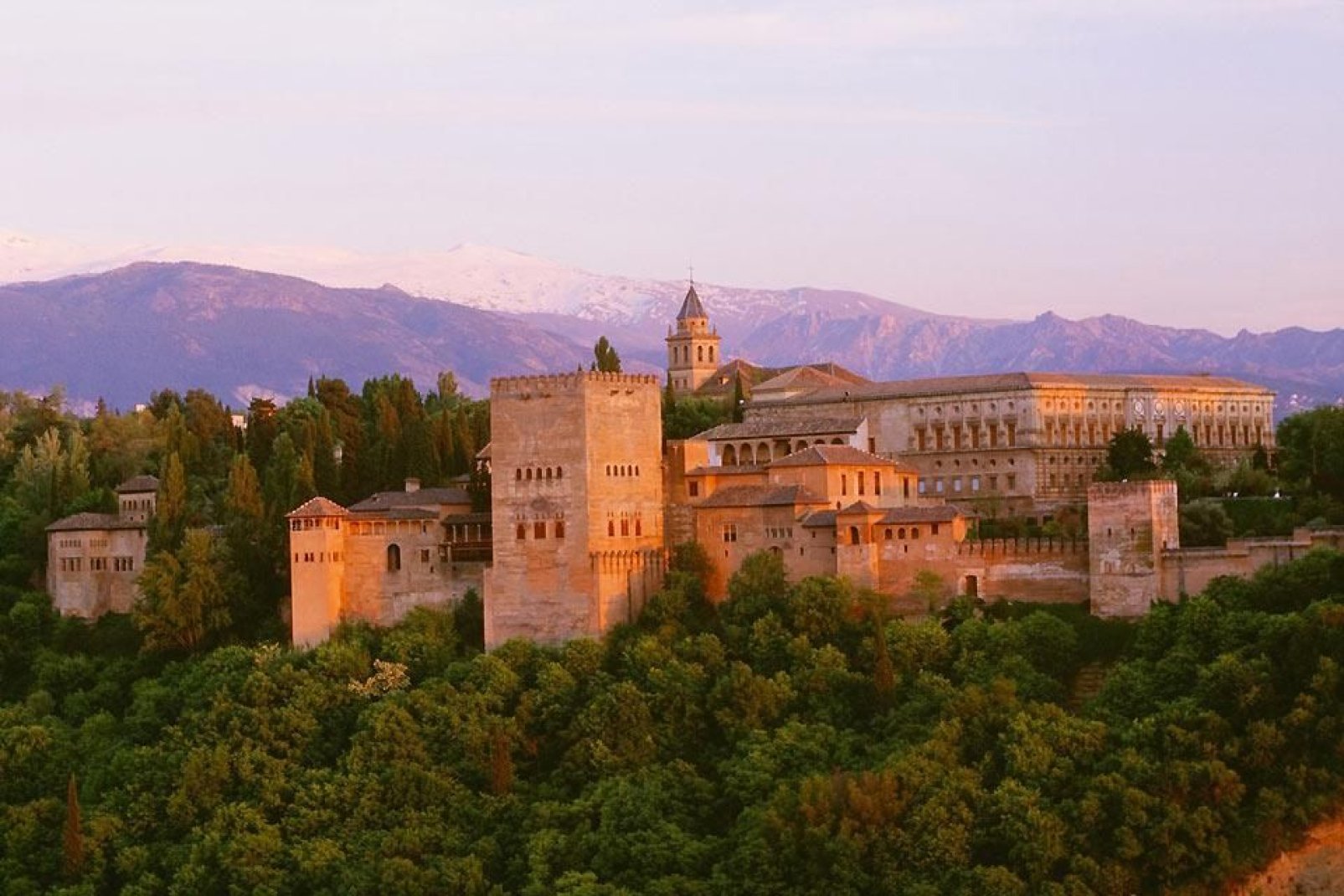 A panoramic view of the Alhambra with the Sierra Nevada in the background.