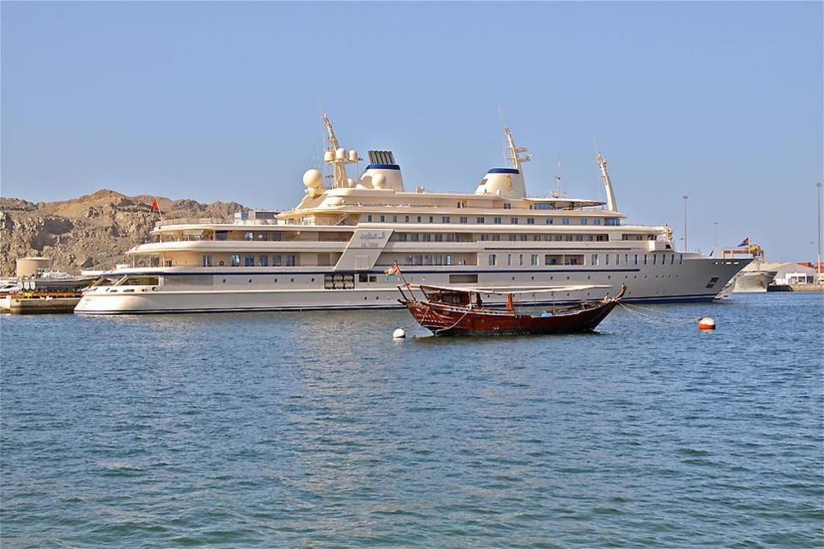 Contraste entre un dhow traditionnel et le luxueux yacht du sultan.