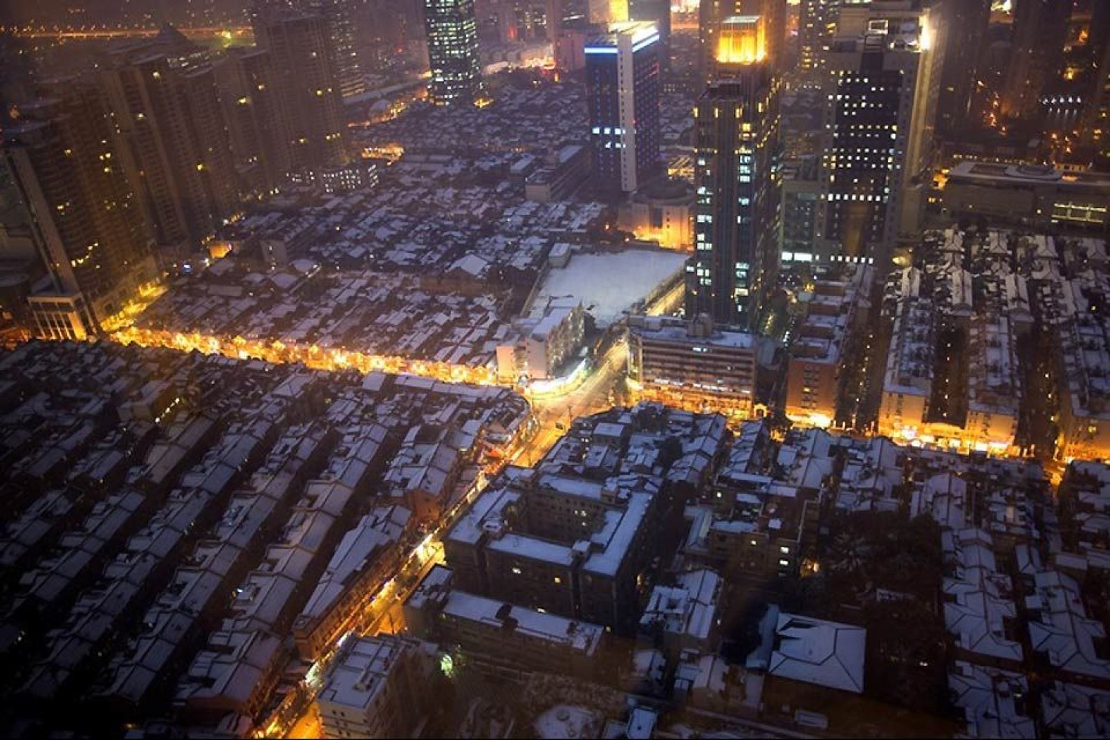 The illuminated streets of Shanghai seen from above.